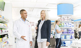 A man and a woman standing in a pharmacy
A man and a woman standing in a pharmacy